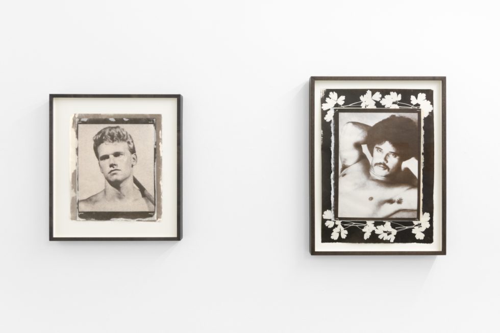 Contemporary artworks displayed along stark white bright gallery walls.