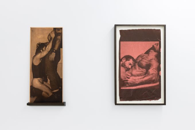 Contemporary artworks displayed along stark white bright gallery walls.