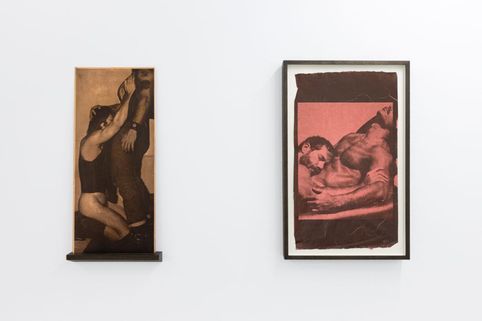 Contemporary artworks displayed along stark white bright gallery walls.