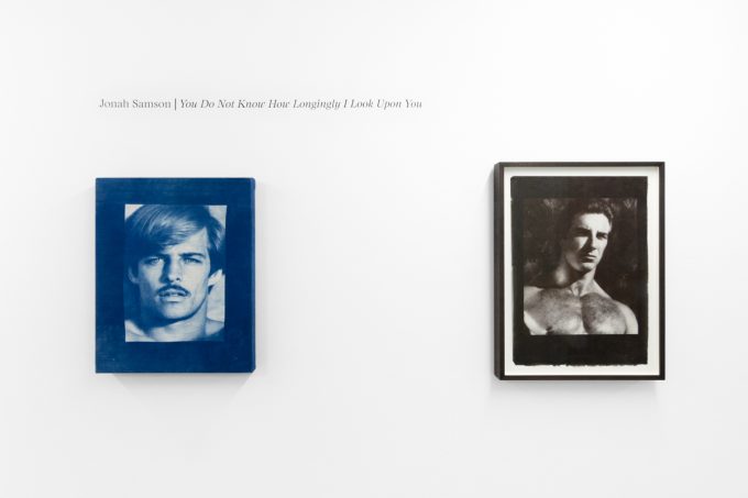 Contemporary artworks displayed along stark white bright gallery walls.