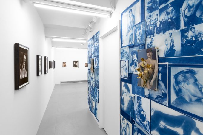 Contemporary artworks displayed along stark white bright gallery walls.