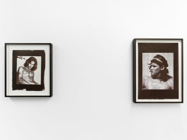 Contemporary artworks displayed along stark white bright gallery walls.