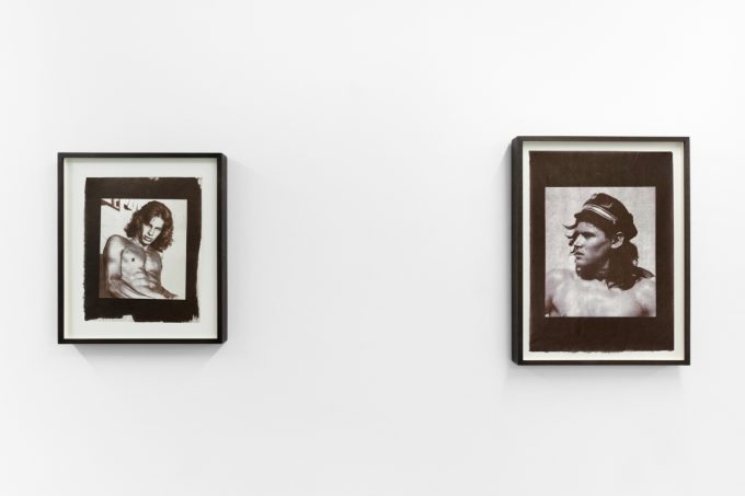 Contemporary artworks displayed along stark white bright gallery walls.