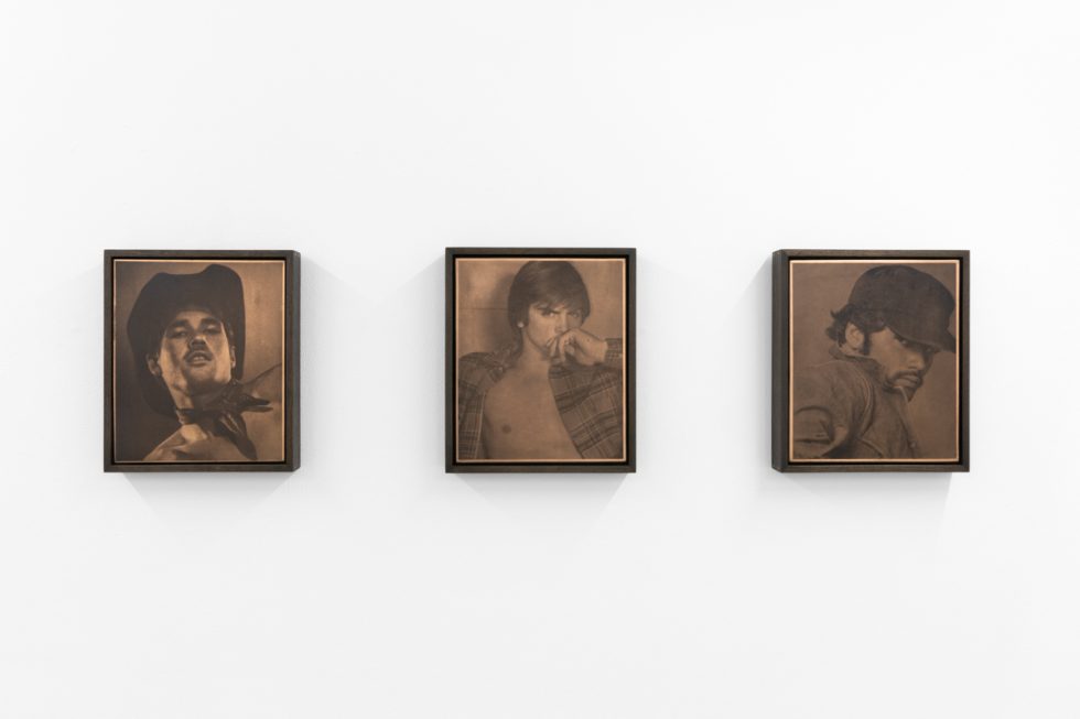 Contemporary artworks displayed along stark white bright gallery walls.