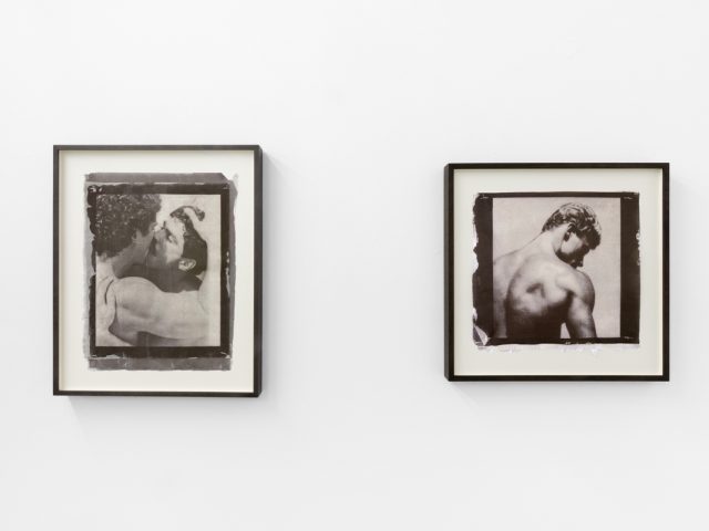 Contemporary artworks displayed along stark white bright gallery walls.