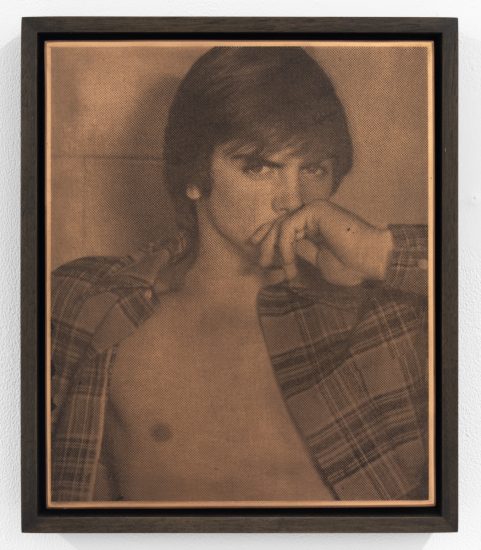 Sepia-toned halftone print of a shirtless person in an open plaid shirt, gazing intensely with hand covering their mouth