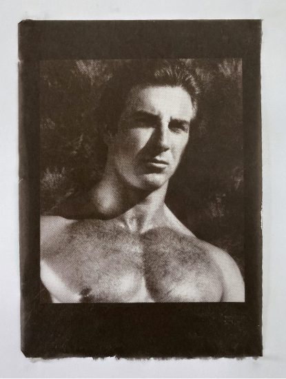 An image of a man's muscular bare chest and head shot.