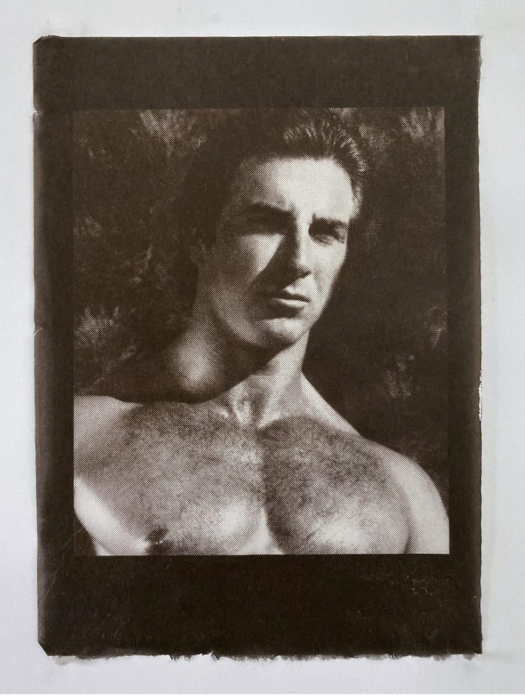 An image of a man's muscular bare chest and head shot.