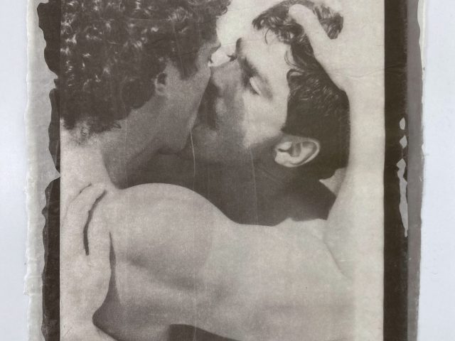 An image showing two people embracing and kissing, with visible thread.