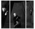 A black and white triptych of three figures behind a curtain in formal attire.