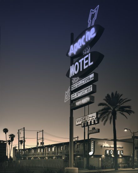 A photograph of a huge neon motel sign.