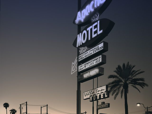 A photograph of a huge neon motel sign.
