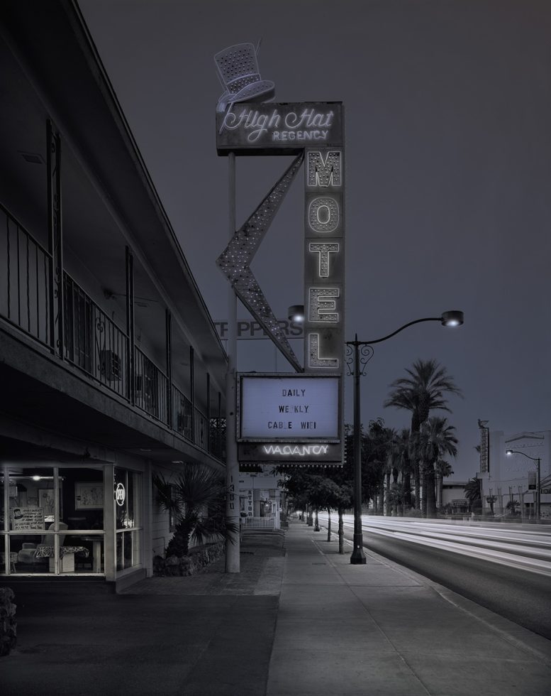 A photograph of a motel with its large vintage sign.