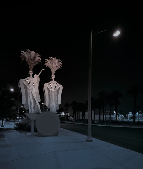 A photograph of two showgirl figures on a street.