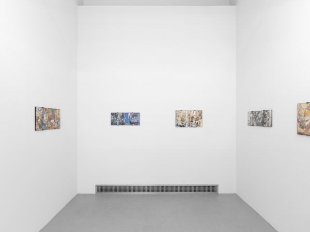 Gallery installation view showing mixed-media works on white walls.