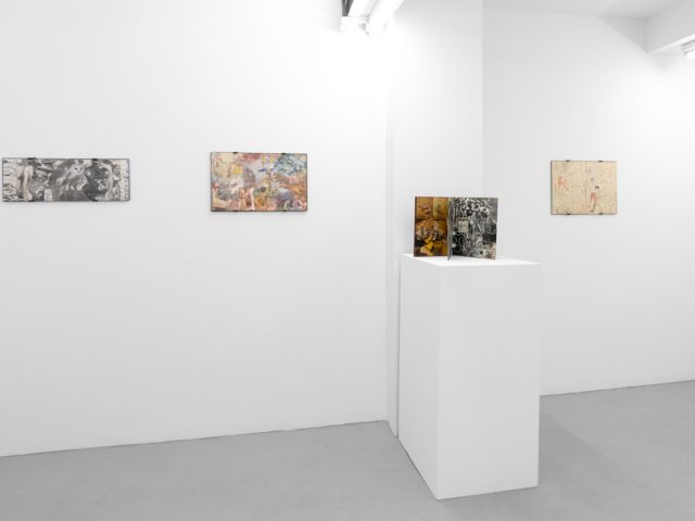 Gallery installation view showing mixed-media works on white walls.