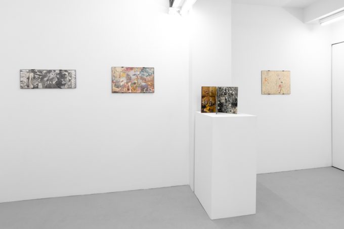 Gallery installation view showing mixed-media works on white walls.
