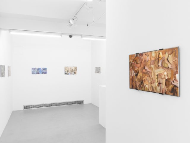 Gallery installation view showing mixed-media works on white walls.