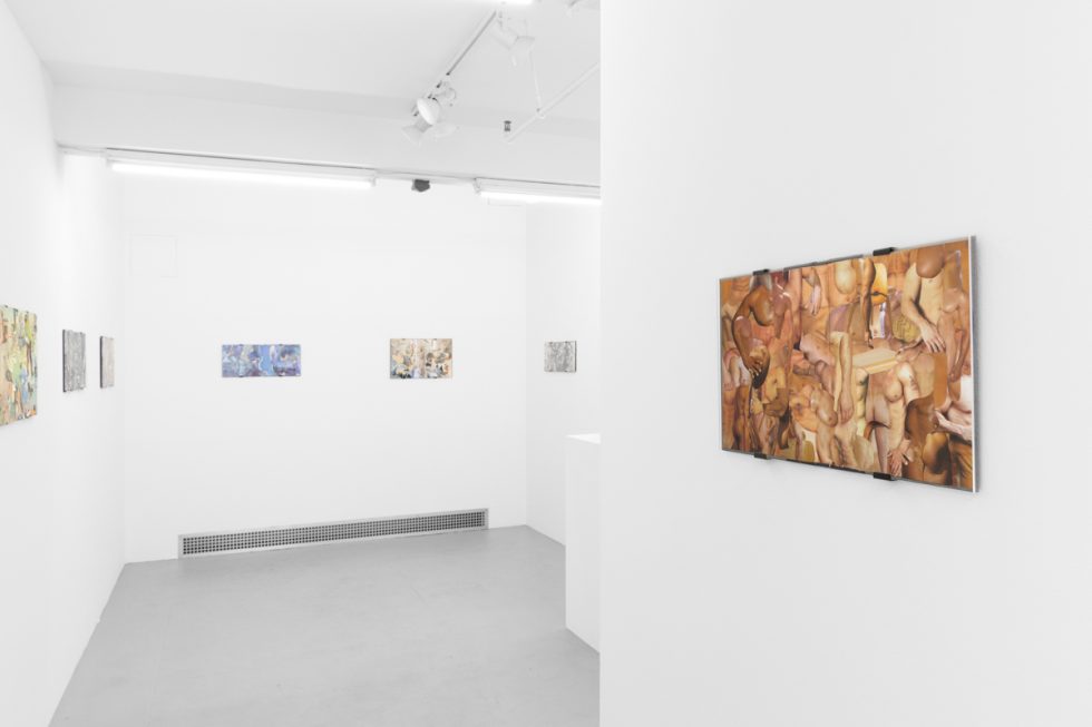 Gallery installation view showing mixed-media works on white walls.