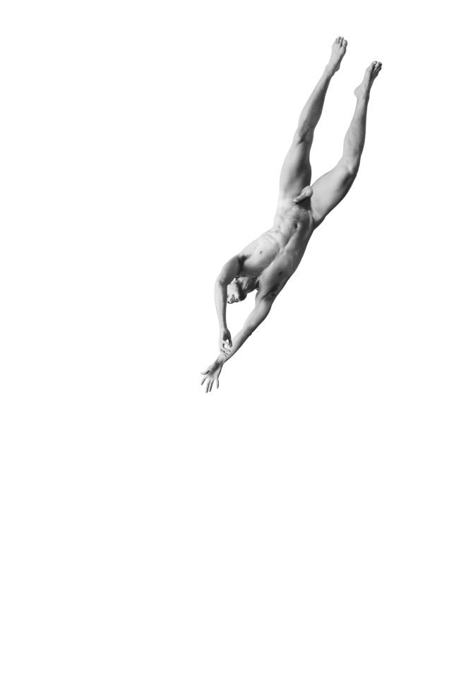 A black and white photograph of a nude man floating through the air on a white background.