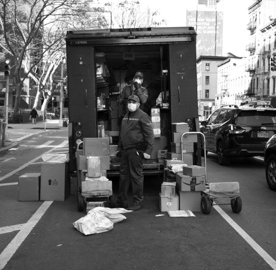 A black and white photograph of UPS deliverymen.