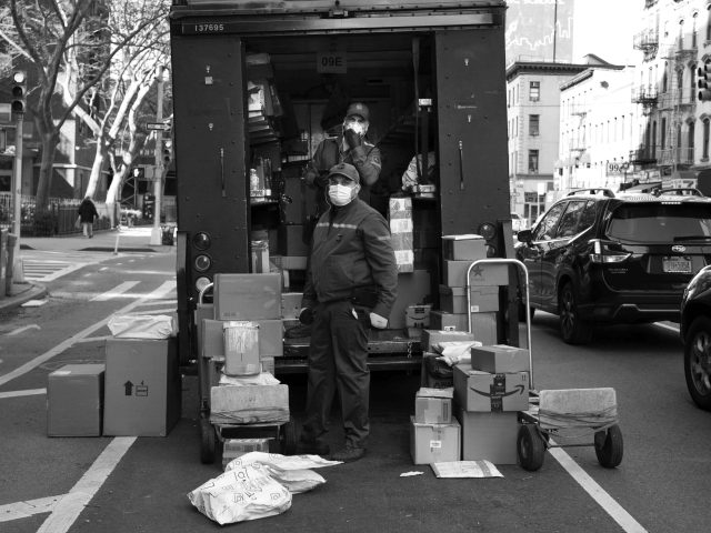 A black and white photograph of UPS deliverymen.