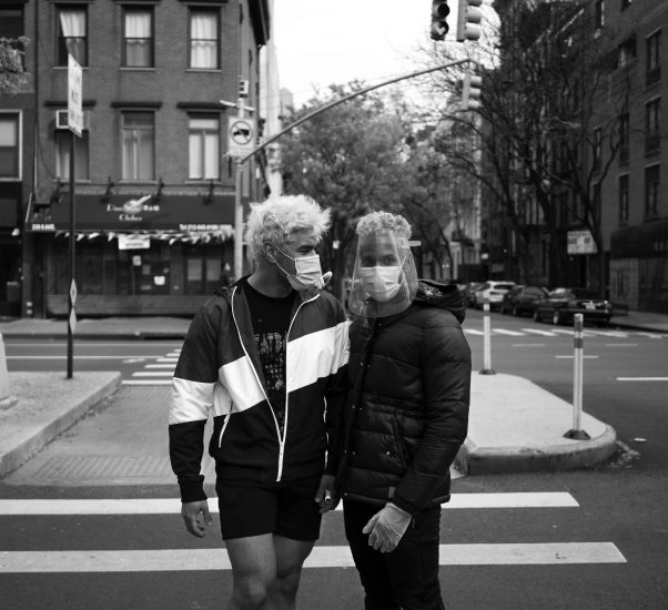 A black and white photograph of two young men with bleached hair.