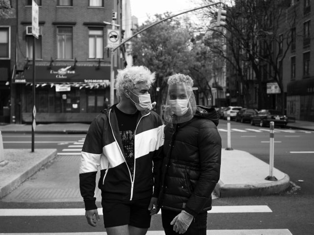 A black and white photograph of two young men with bleached hair.