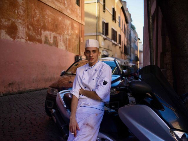 A photograph of a cook in Rome on his Break.