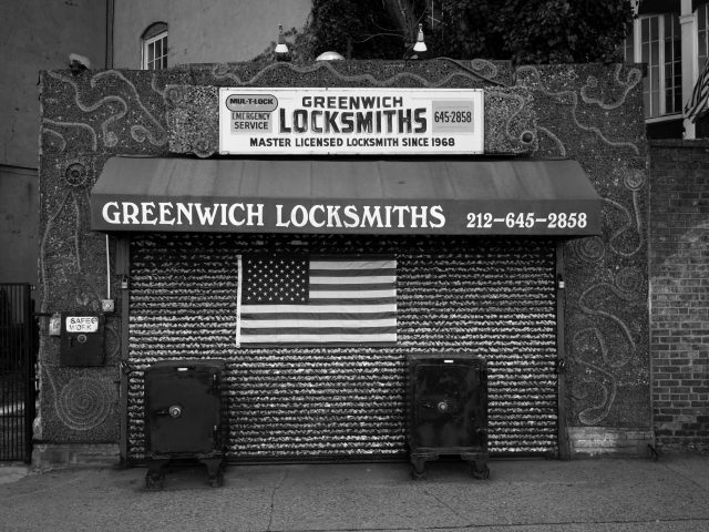 A black and white photograph of a locksmith storefront.