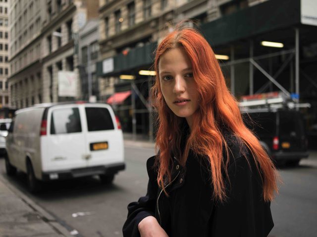 A photograph of a gorgeous young woman with red hair.