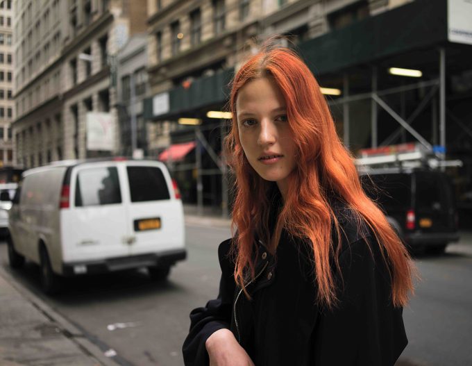 A photograph of a gorgeous young woman with red hair.