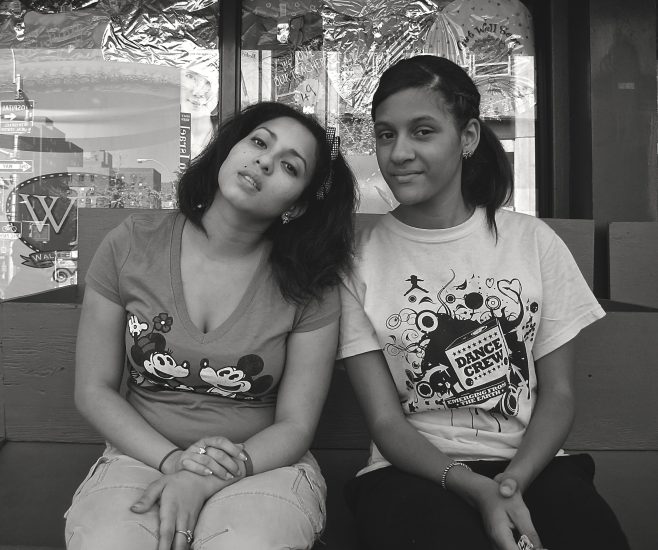A black and white photograph of two young women at the bodega.