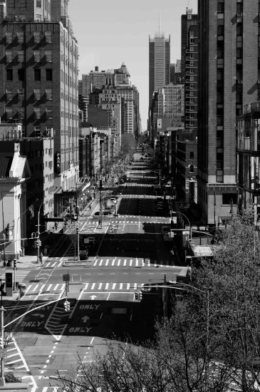 A black and white photograph of a street with no cars photographer from above.