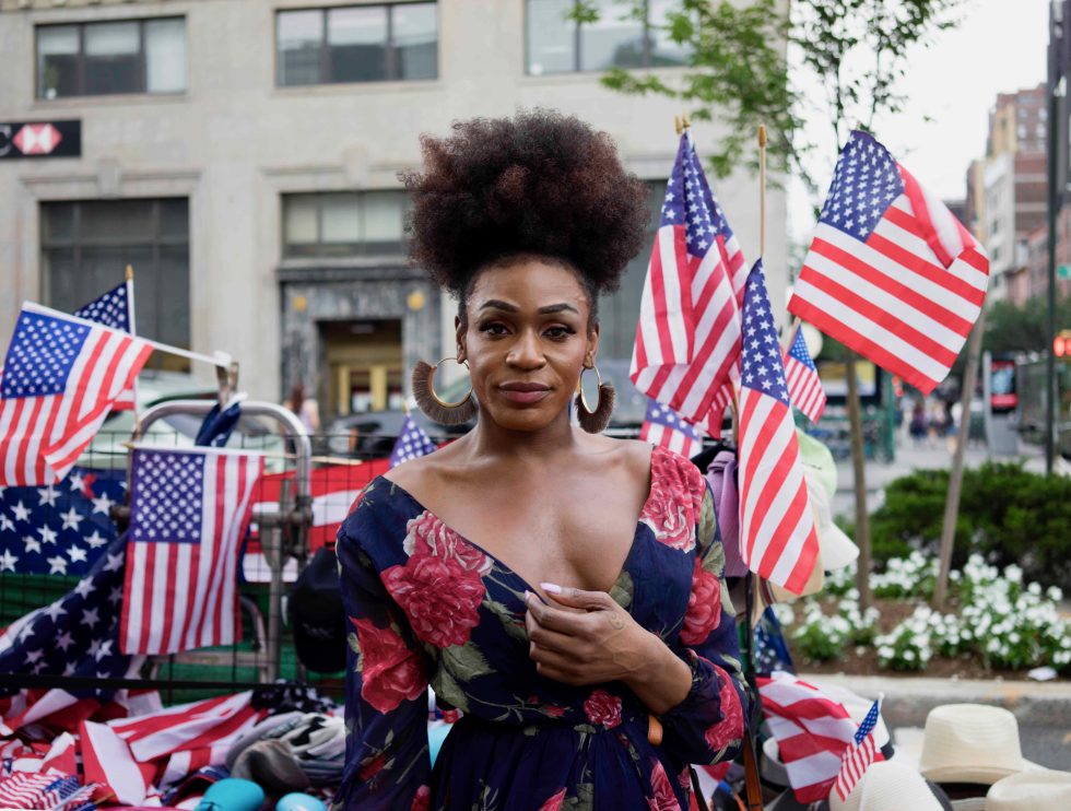 A photograph of a patriotically dressed woman at a parade.