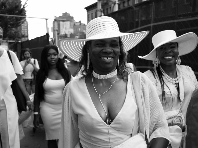 A black and white photograph of joyous women celebrating.