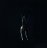 A dark photograph of a subtle silhouette of a woman.