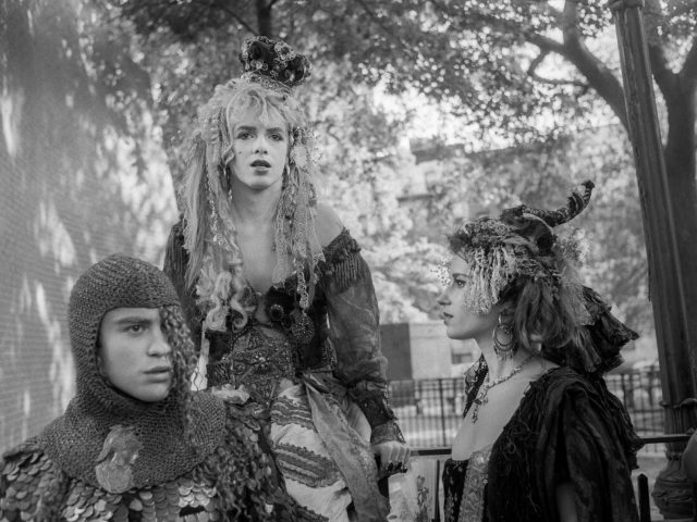 A black and white photograph of a group of people in costumes in a park.
