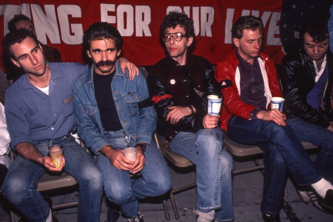 A color photograph of four men at an AIDS vigil.