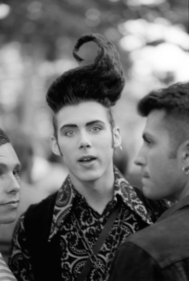 A black and white photograph of a man with wild hair.