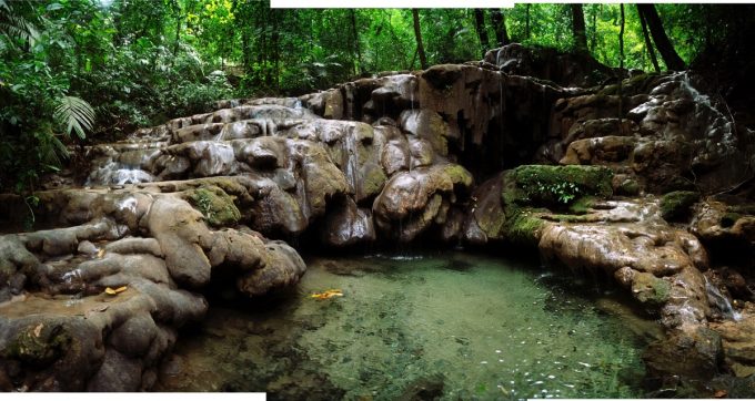 A photograph of a body of water in front of rocks.