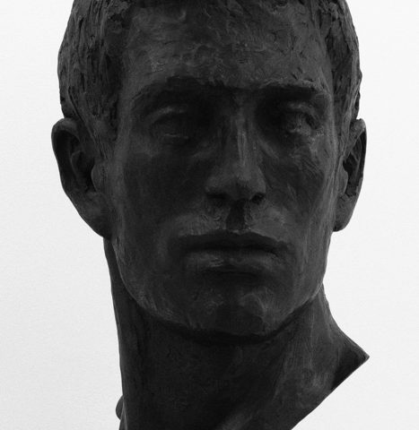 A bronze bust of a man's head.