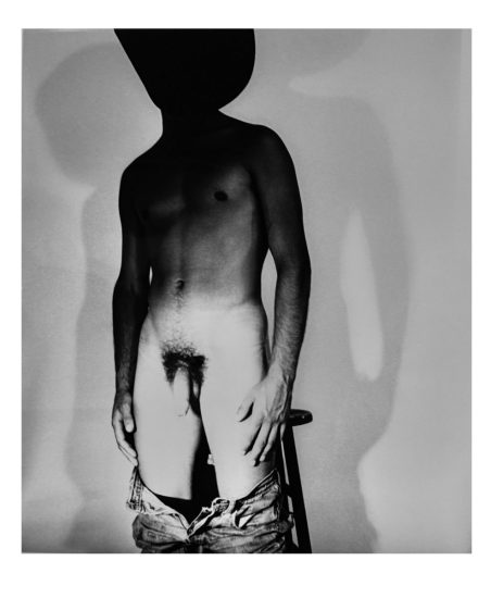 A black and white nude photograph of a man in a cowboy hat.