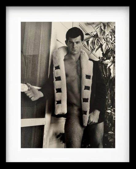 A black and white photograph of a partially nude man.