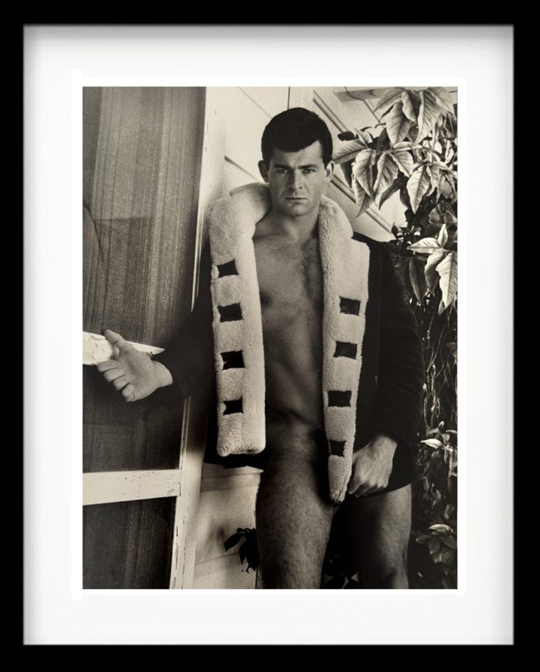 A black and white photograph of a partially nude man.