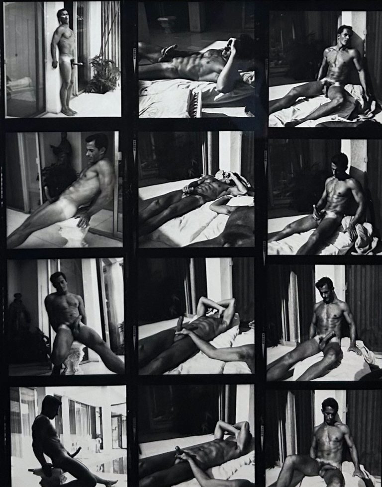 A black and white photograph of a nude man sitting outside in the sun.