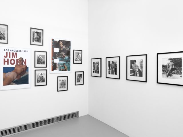 An installation photograph of black and white photography in a white-walled gallery space.