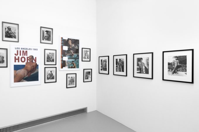 An installation photograph of black and white photography in a white-walled gallery space.