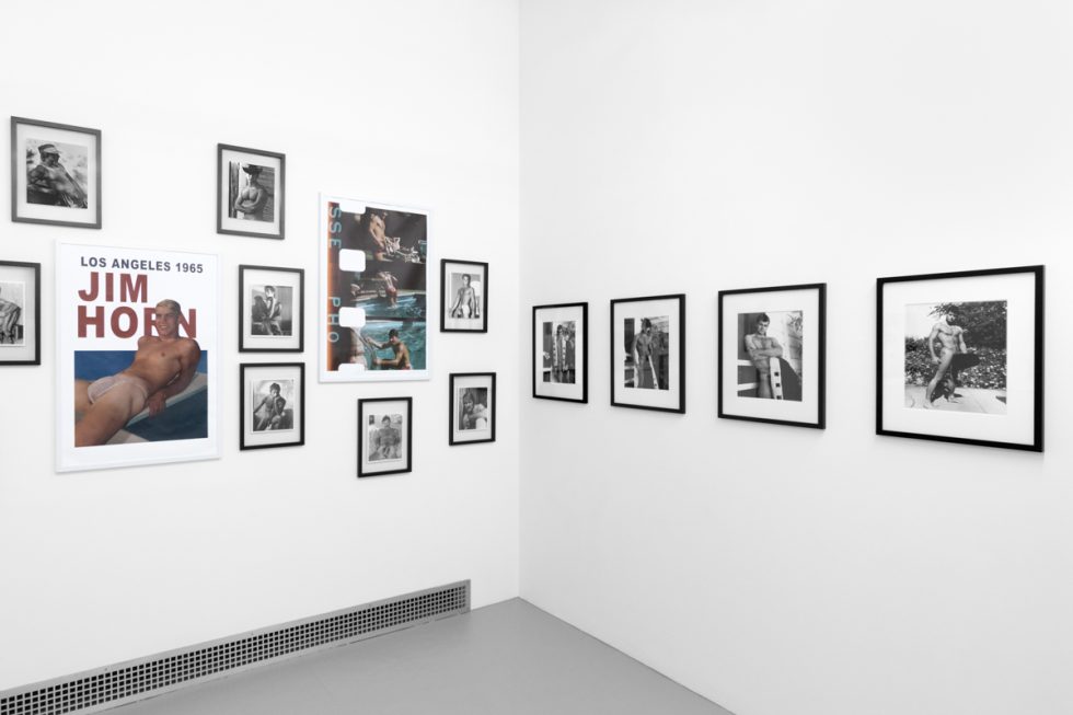 An installation photograph of black and white photography in a white-walled gallery space.