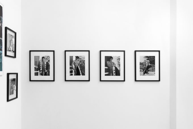 An installation photograph of black and white photography in a white-walled gallery space.